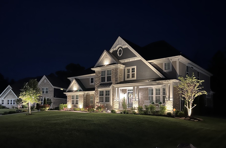 Hamilton Home Accents nighttime exterior lighting on a luxury home